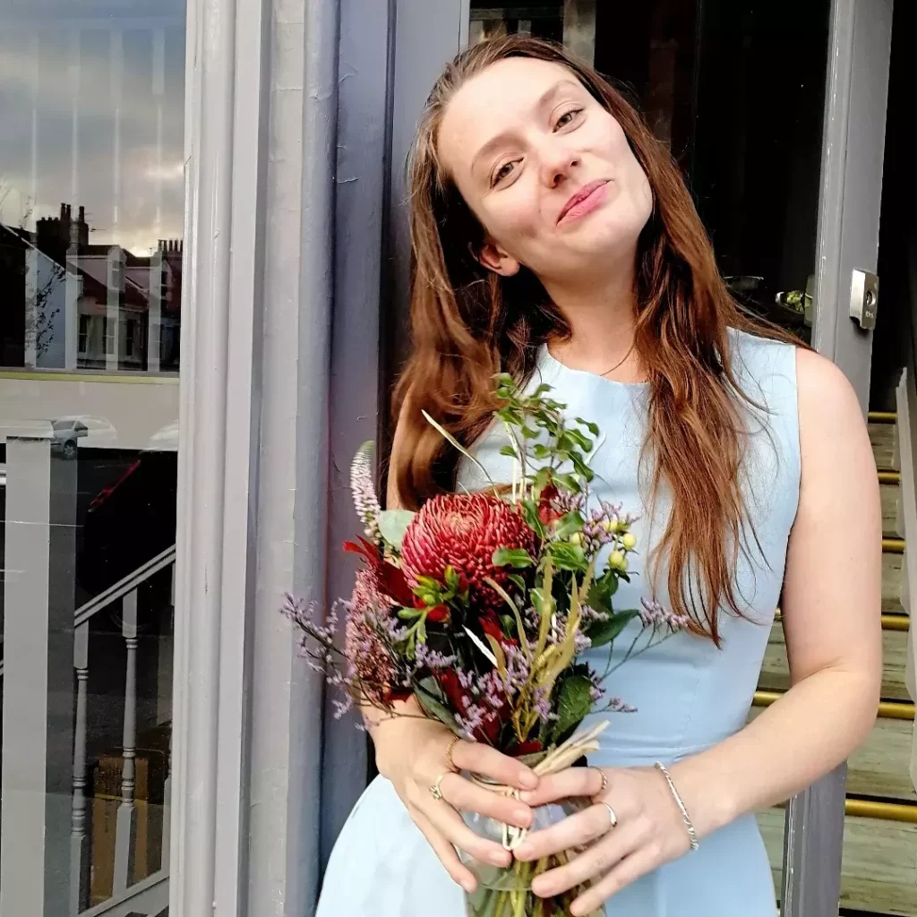 Stephie with bouquest of dried flowers outside shop in Portland Road, Hove